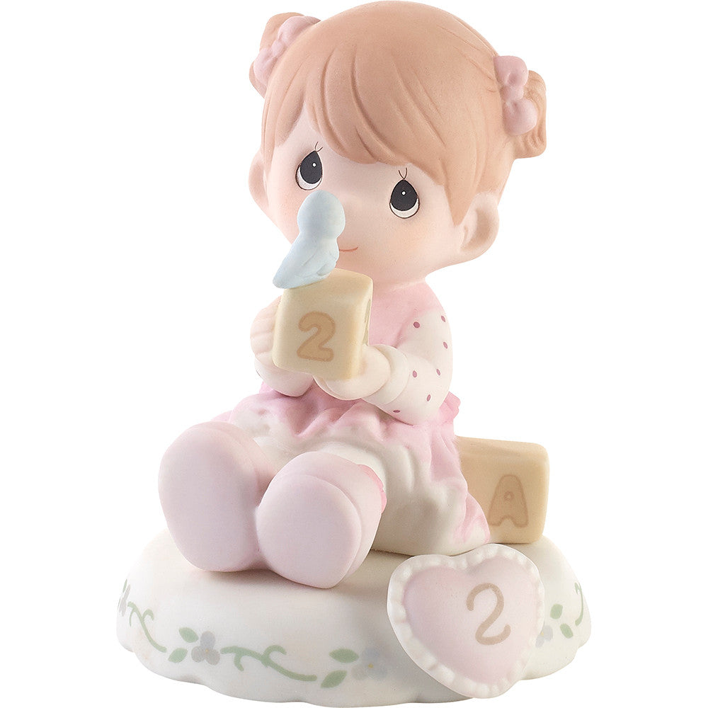 Redhead haired girl holding blocks with blue bird age 2 shown on base - side view