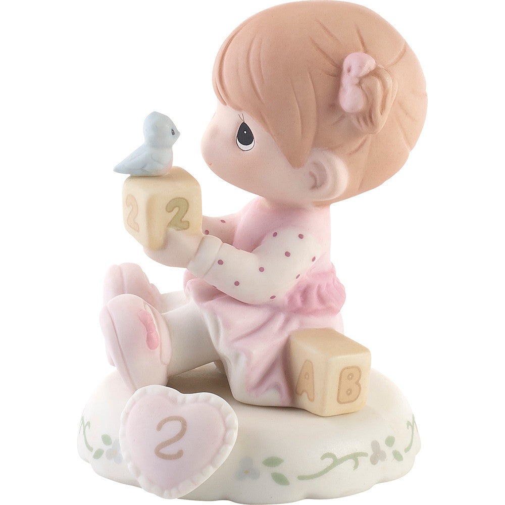 Redhead haired girl holding blocks with blue bird age 2 shown on base - side view