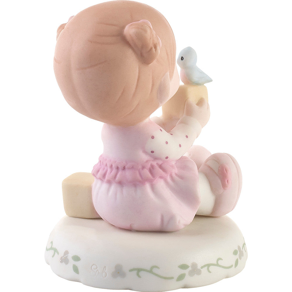 Redhead haired girl holding blocks with blue bird age 2 shown on base - back view