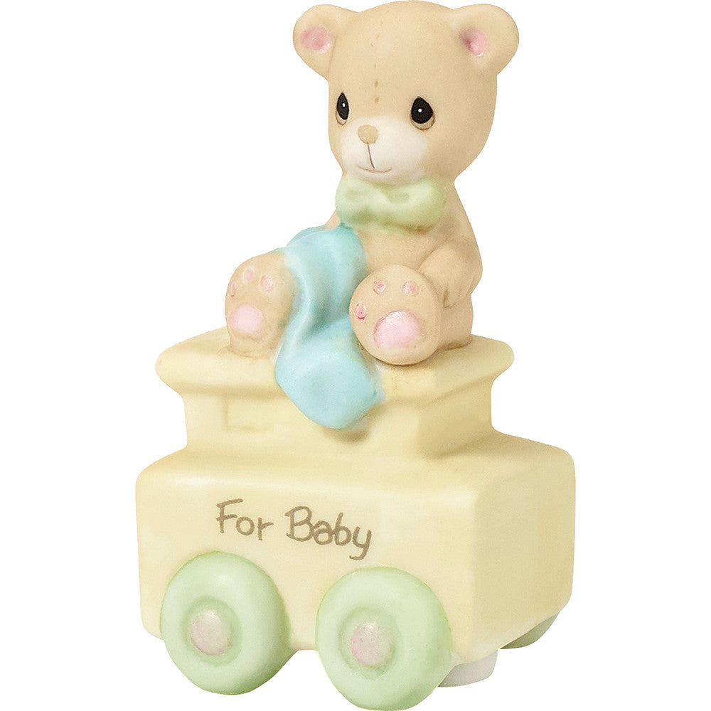 Teddy bear with blanket on train car with For Baby on the side - side view