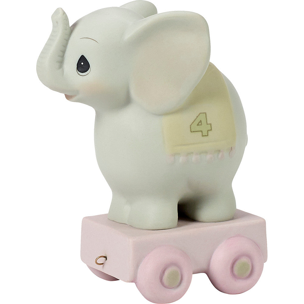 Grey elephant on platform with age 4 on blanket over back - side view