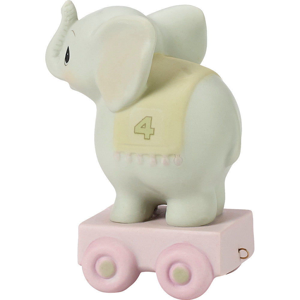 Grey elephant on platform with age 4 on blanket over back - side view