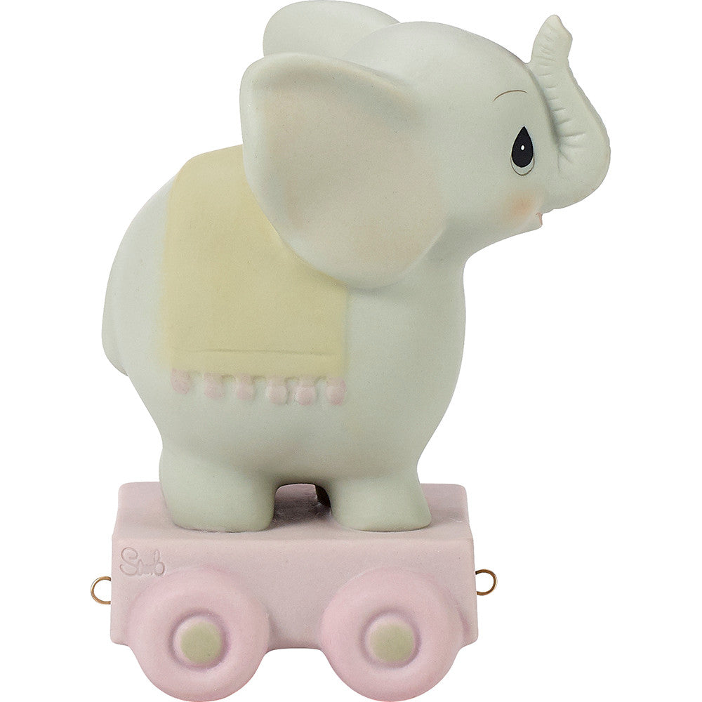 Grey elephant on platform with age 4 on blanket over back - back view