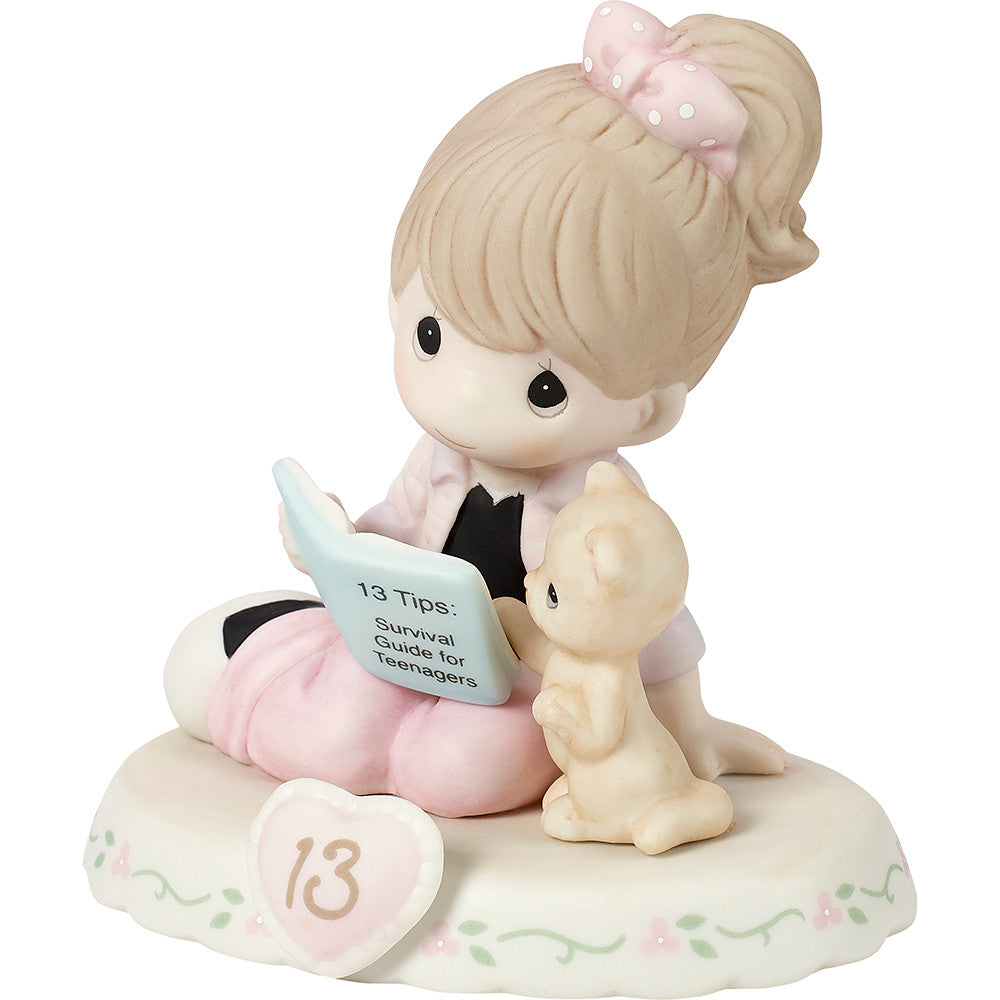 Brunette haired girl with cat reading book with age 13 on the base - side view