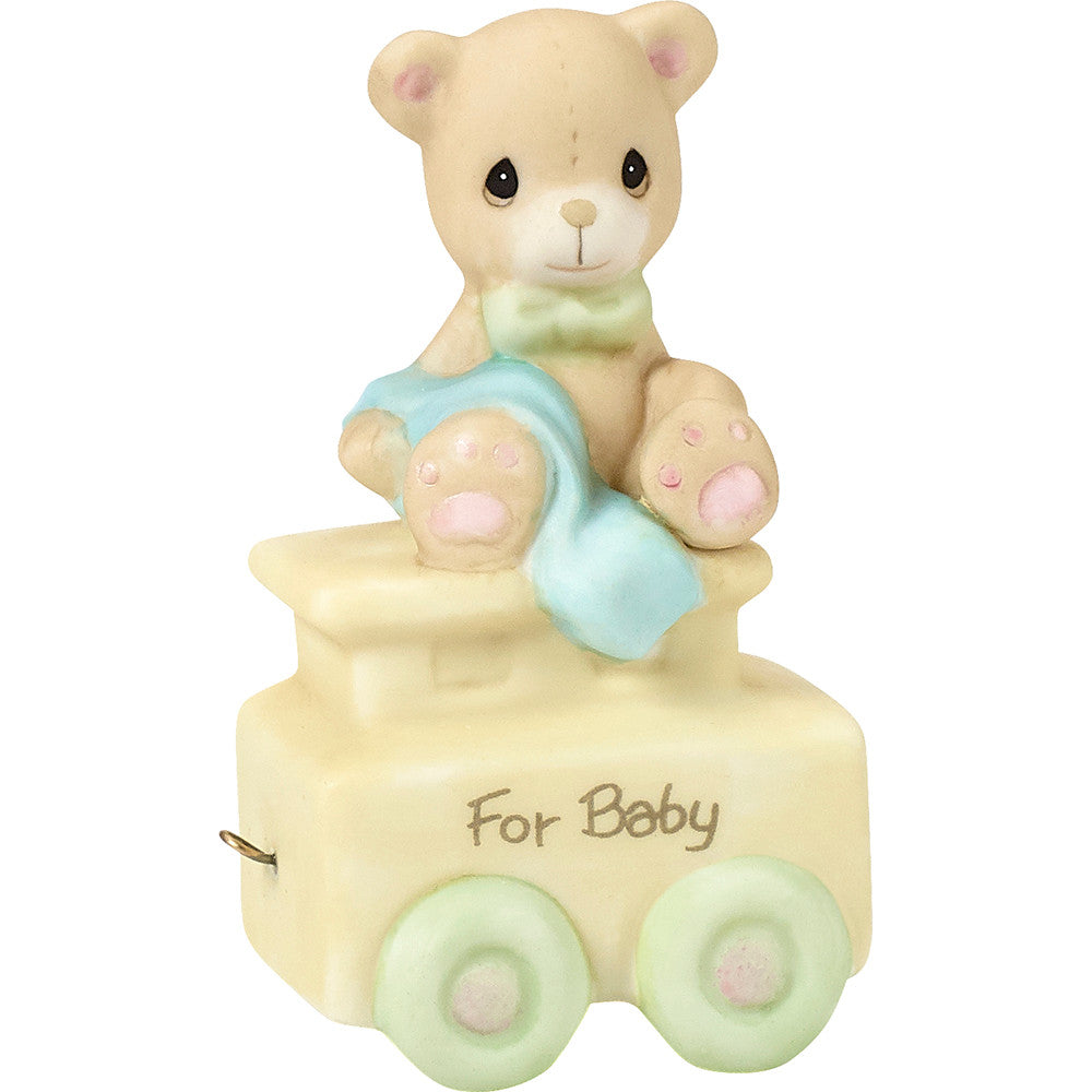 Teddy bear with blanket on train car with For Baby on the side - side view