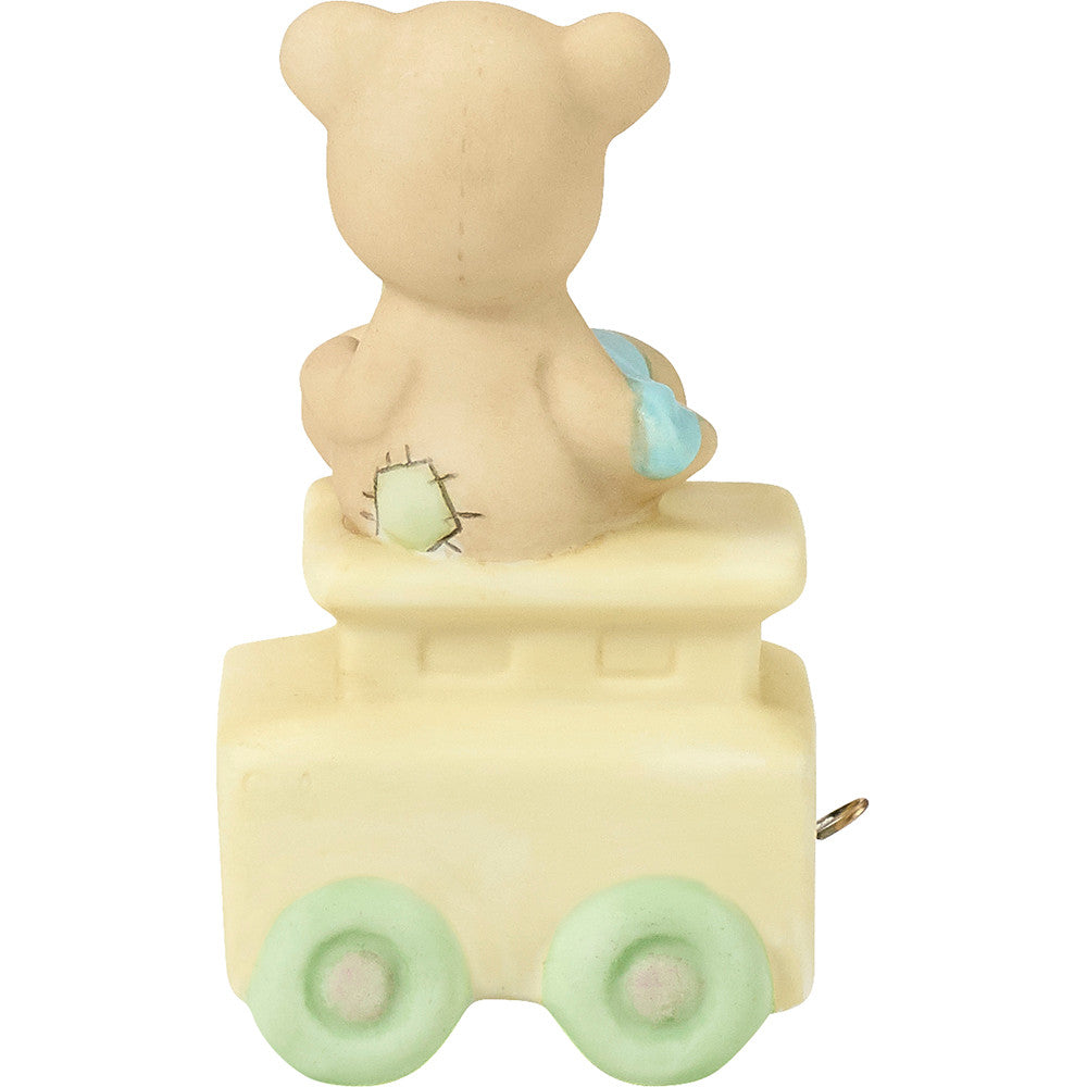Teddy bear with blanket on train car with For Baby on the side - back view