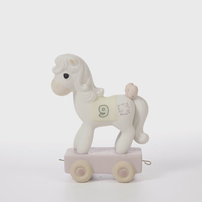 White pony on pink platform with age 9 on side -360 video