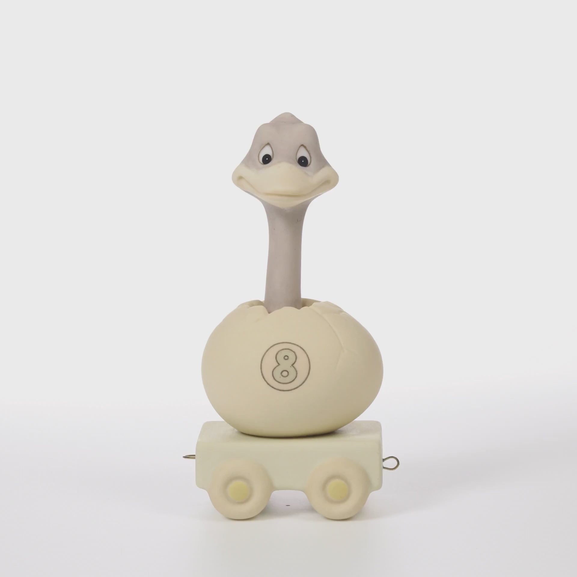 Ostrich popping out of egg on platform with age 8 on the side of shell - 360 video