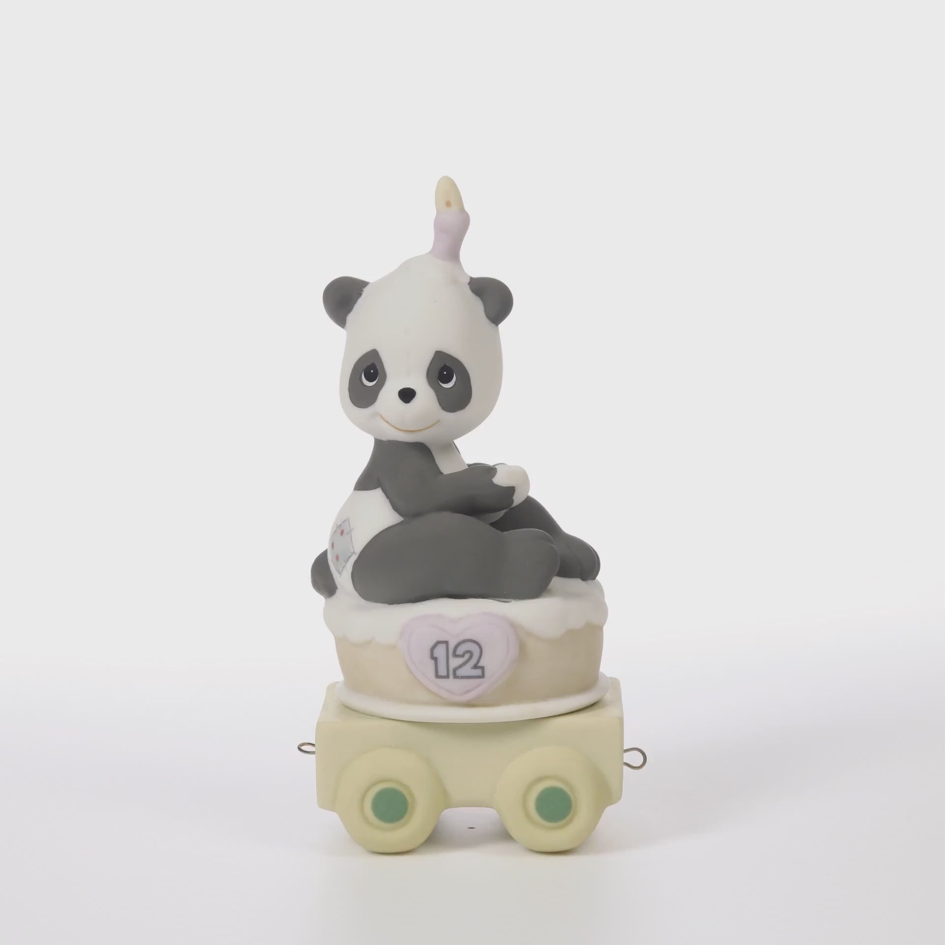 Panda bear sitting on birthday cake with candle on head with age 12 on side of cake - 360 video