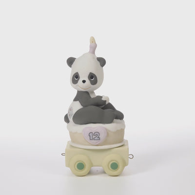 Panda bear sitting on birthday cake with candle on head with age 12 on side of cake - 360 video