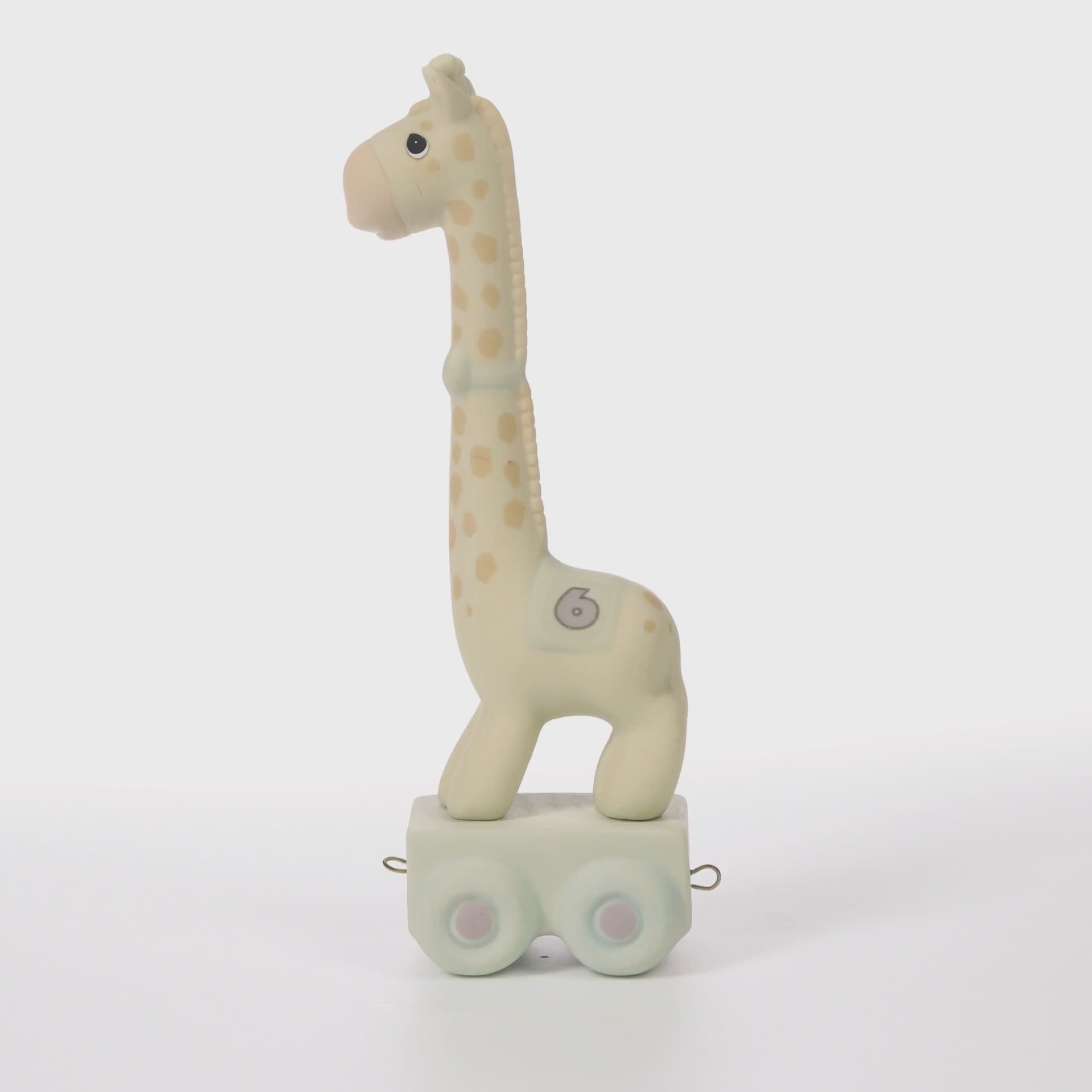 Giraffe with blanket featuring age 6 on side standing on platform - 360 video