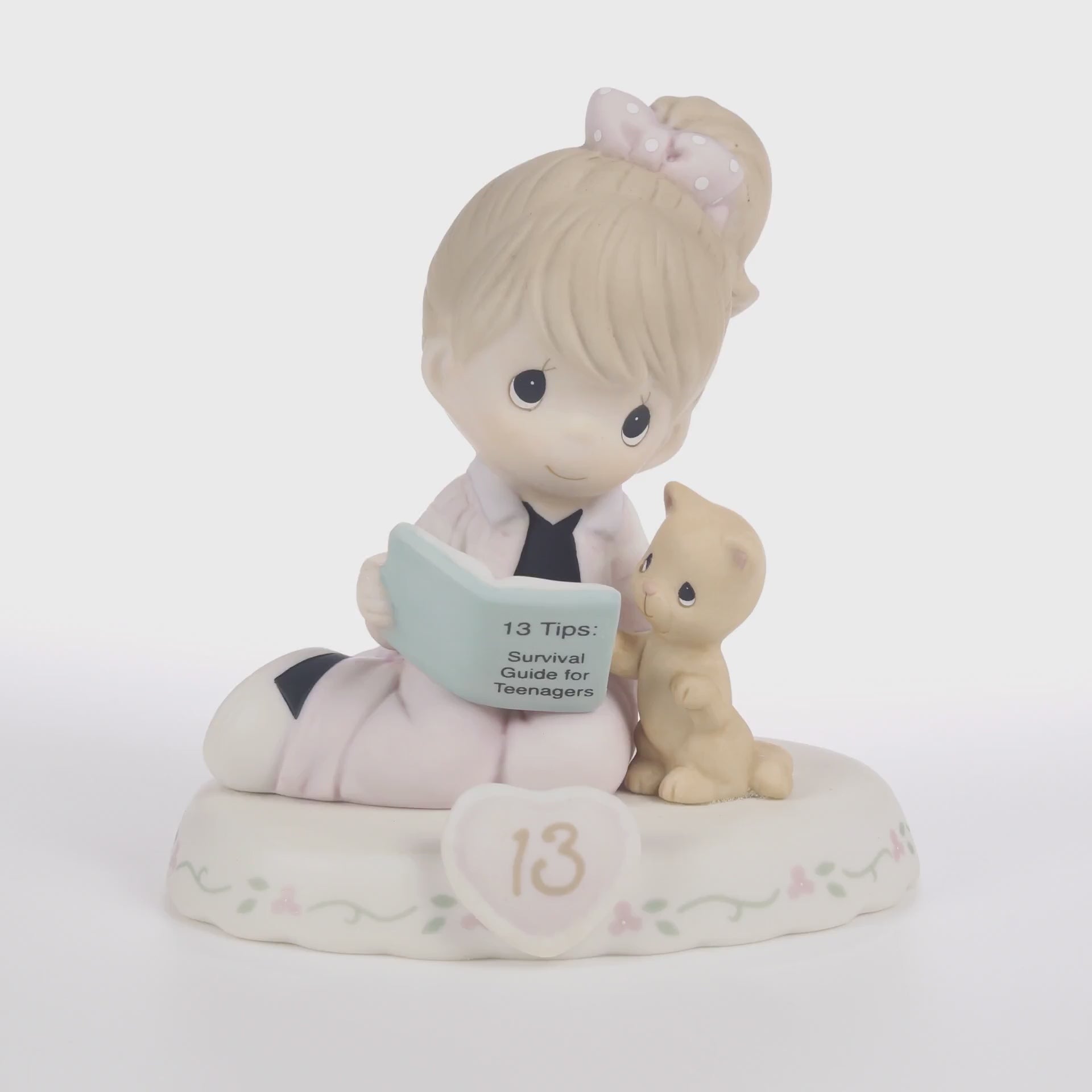 Brunette haired girl with cat reading book with age 13 on the base - 360 video